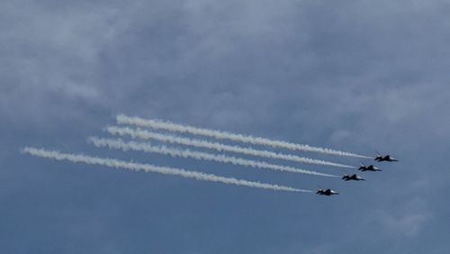 Low angle view of airplane flying against sky