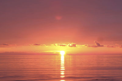 Scenic view of sea against romantic sky at sunset