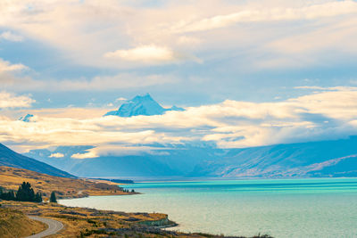 Scenic view of sea and mountains against sky