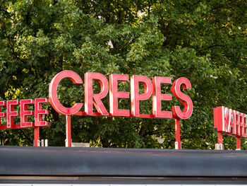 Information sign against trees in city