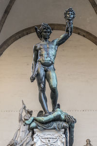 Low angle view of statue against wall