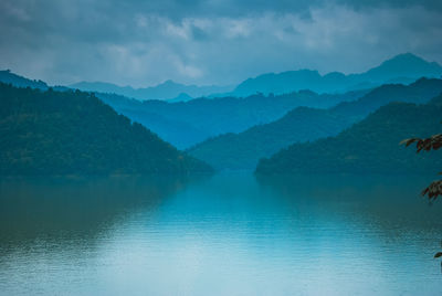 Scenic view of lake and mountains against sky