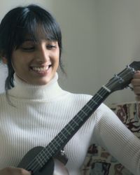 Young woman playing guitar