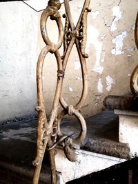 Close-up of rusty metal chain against wall