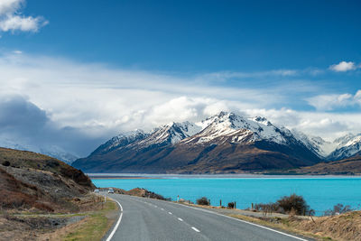 Mount cook road alongside lake pukaki with snow capped southern alps in winter evening light. 