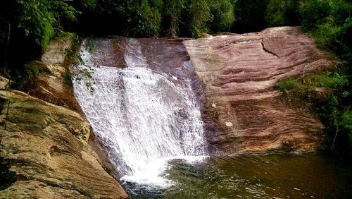 Scenic view of river flowing through rocks