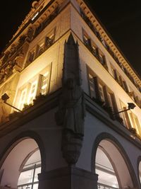 Low angle view of illuminated building against sky at night