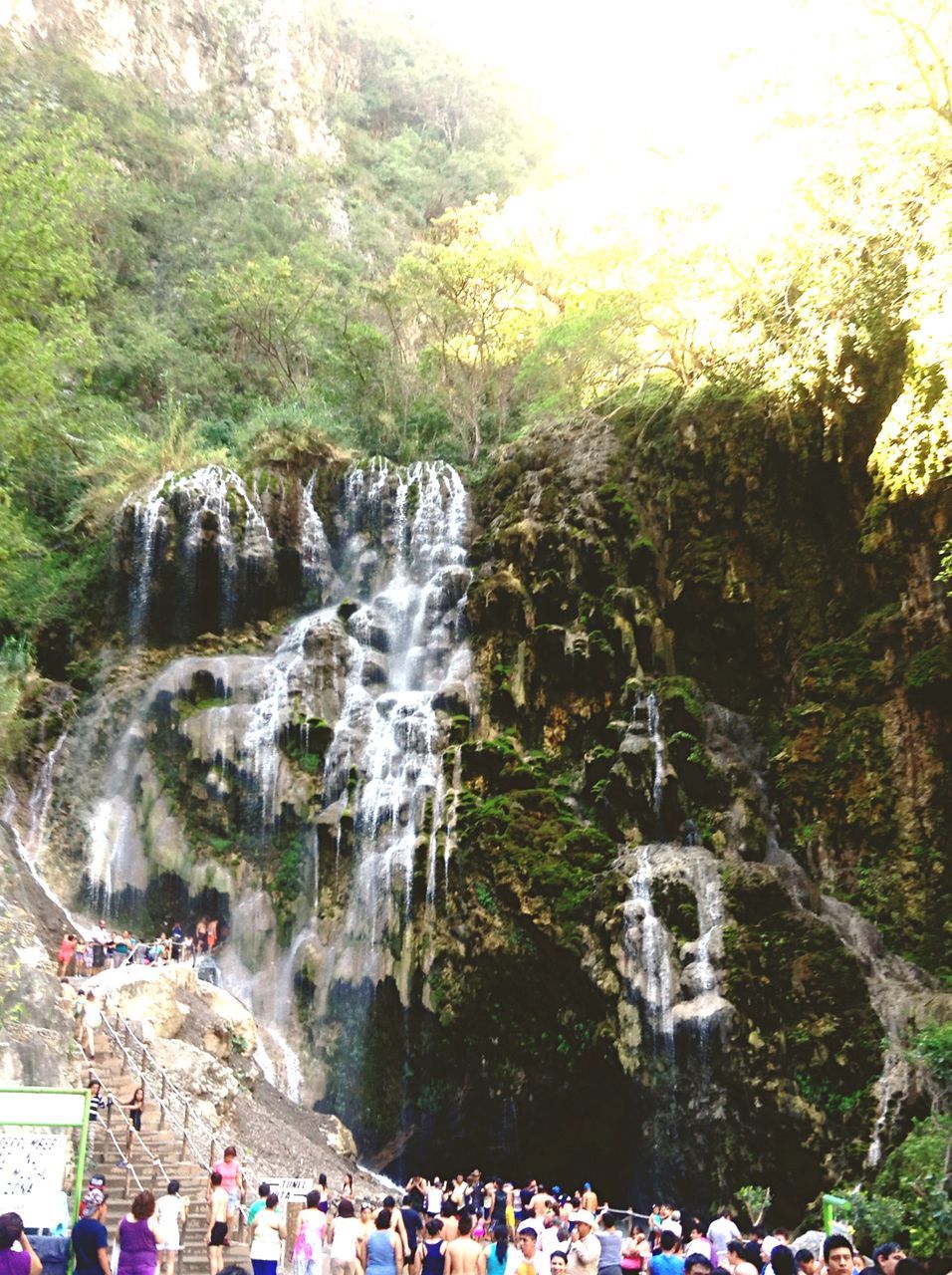 large group of people, tree, water, lifestyles, leisure activity, person, men, tourist, motion, waterfall, tourism, vacations, nature, mixed age range, rock - object, travel destinations, flowing water, travel, beauty in nature