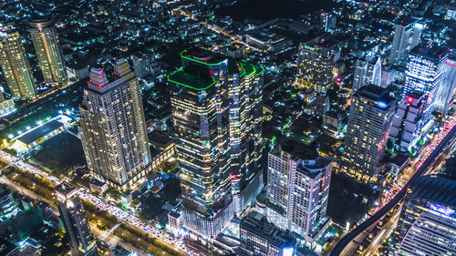 High angle view of illuminated buildings in city at night