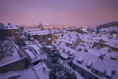 Prague in winter. view of snowy roofs of lesser town at night.