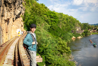 Portrait of man standing on railroad track 