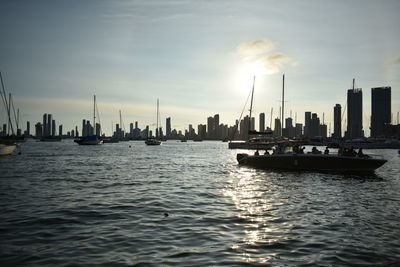 Boats sailing in river during sunset