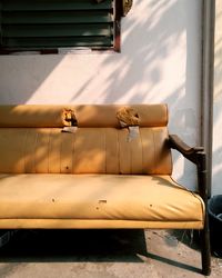 Abandoned sofa against white wall