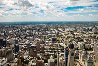 Aerial view of city against cloudy sky