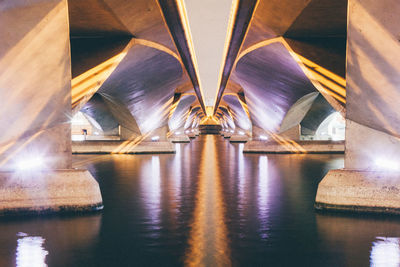 Reflection of illuminated bridge in water