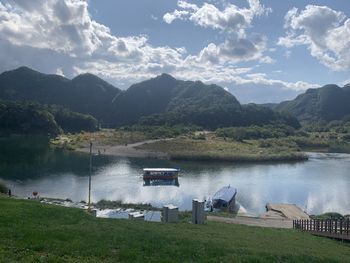 Scenic view of lake and mountains against sky