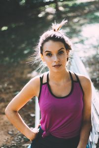 Portrait of teenage girl standing by bench