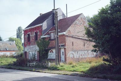 Houses by road against buildings in city