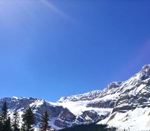 Scenic view of snowcapped mountains against clear blue sky