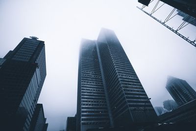 Low angle view of modern buildings against sky in city