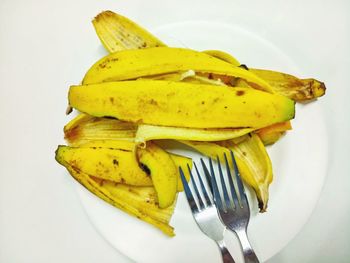 Close-up of yellow slices over white background