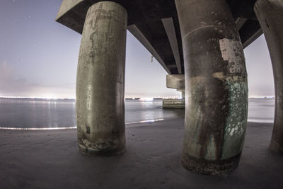 Below view of bridge over sea against sky