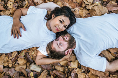 Couple relaxing on autumn leaves