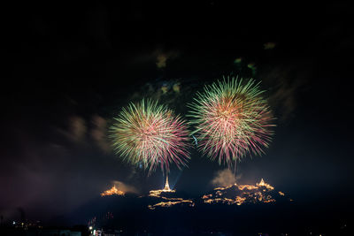 Low angle view of firework display at night