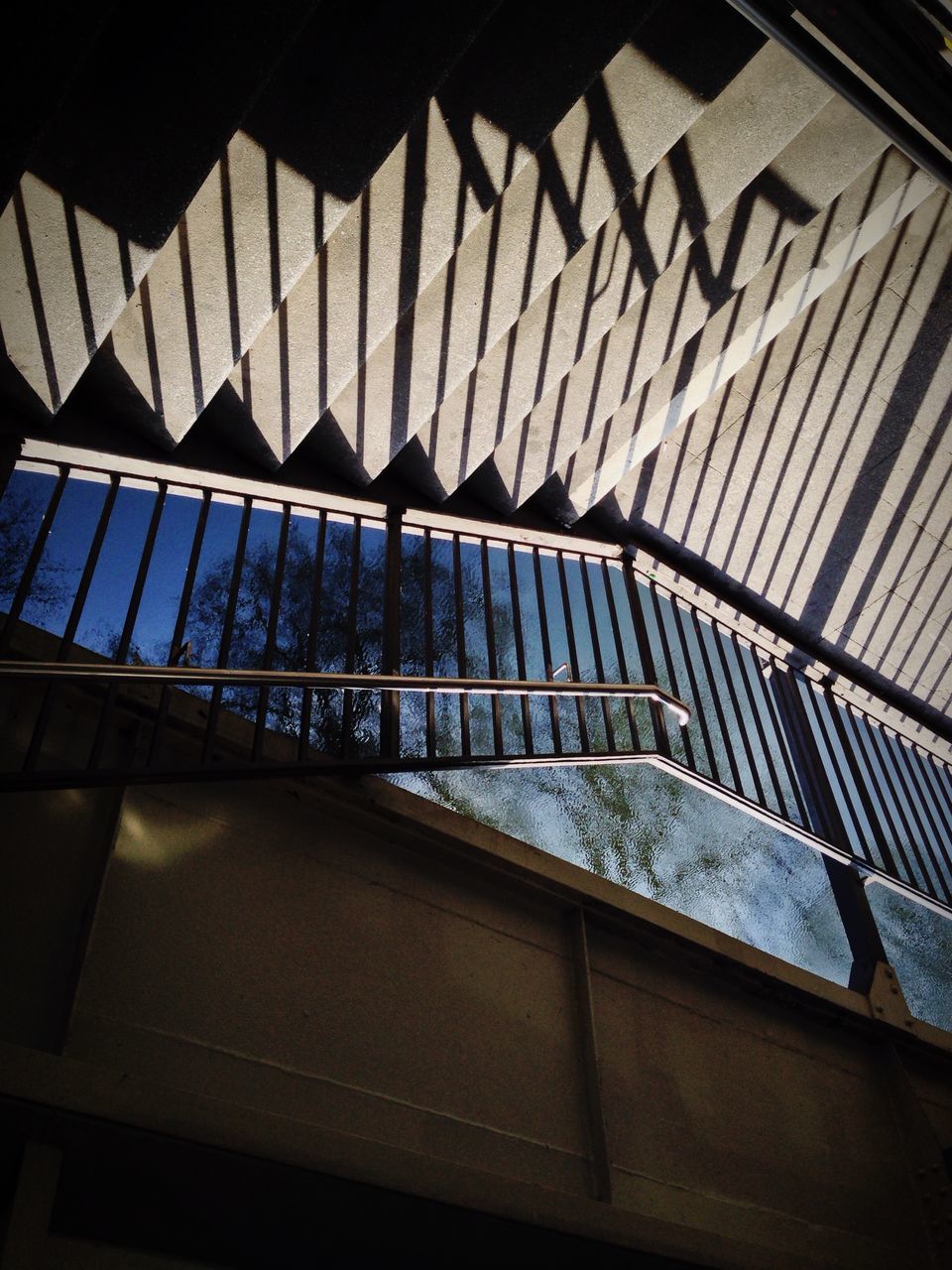 indoors, architecture, built structure, high angle view, pattern, shadow, sunlight, wall - building feature, building exterior, no people, railing, window, day, building, low angle view, design, metal, ceiling, wall, reflection