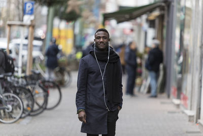 Man standing on street in city