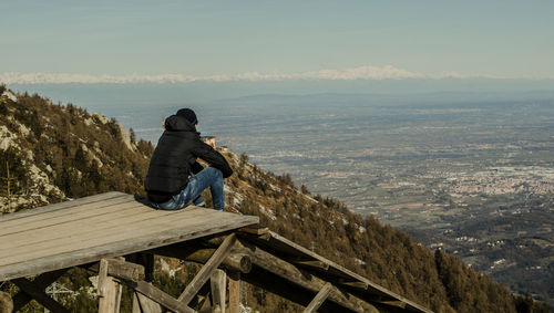 Man sitting against landscape