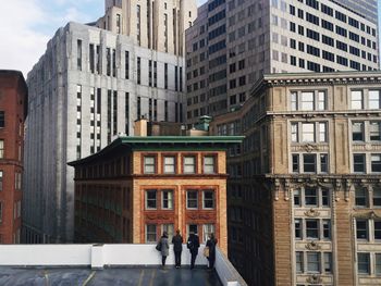 High angle view of people on terrace against buildings