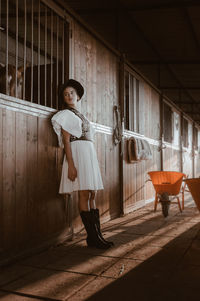 Full length portrait of woman standing at home