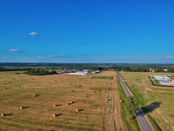 High angle view of agricultural field against blue sky