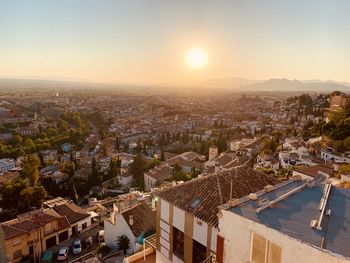 High angle shot of townscape against sky at sunset