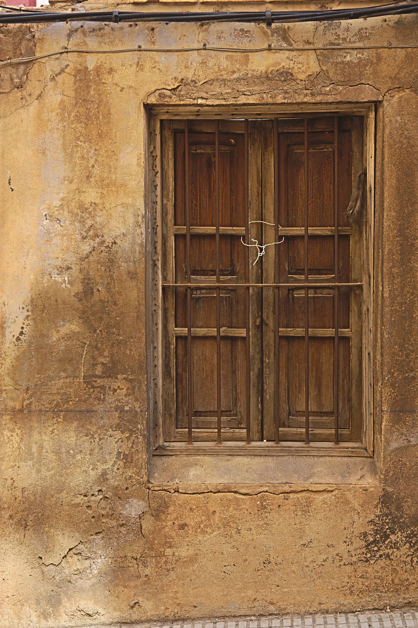 CLOSED WOODEN DOOR OF OLD BUILDING