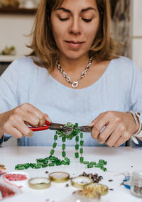 Close-up of young woman eating food on table