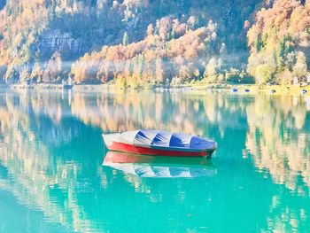 Boats moored on lake against sky