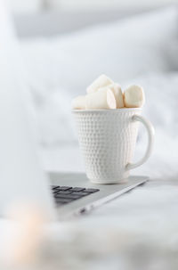 Close-up of chocolate cup with marshmallow on table