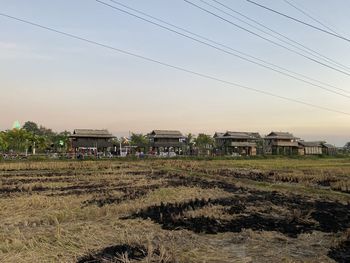 Houses on field against sky