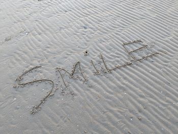 High angle view of text on sand at beach