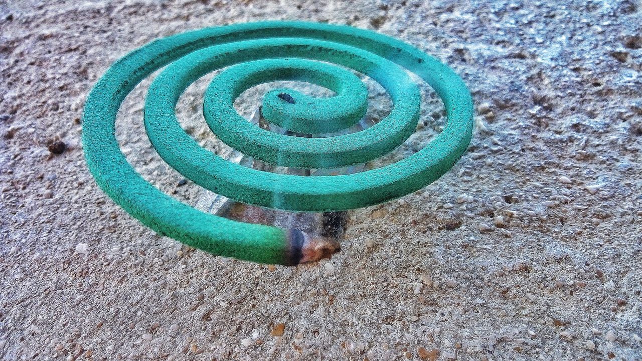 HIGH ANGLE VIEW OF GREEN PIPE ON LAND