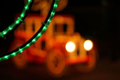 Illuminated christmas lights against toy