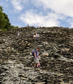 People walking on land against sky