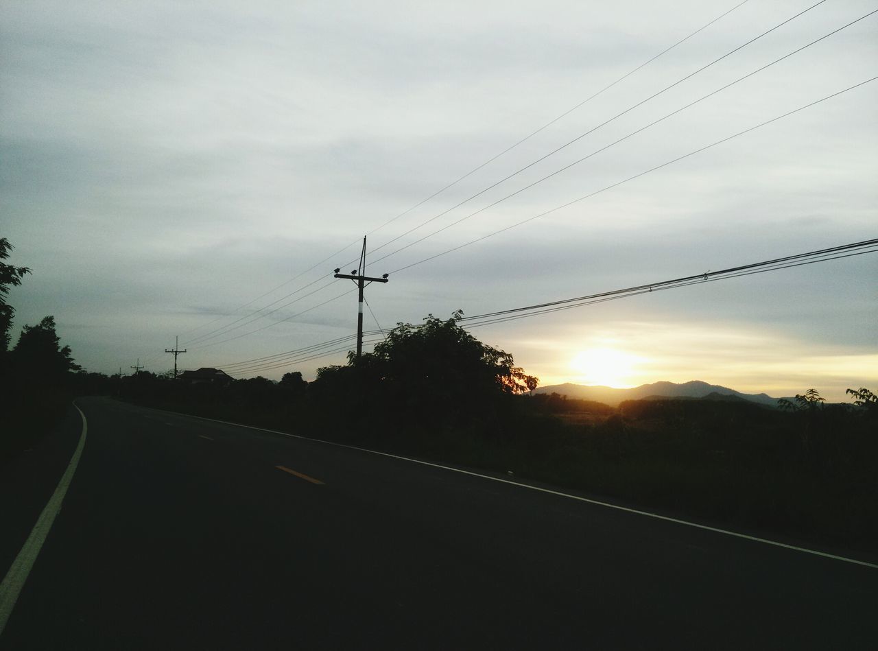 transportation, power line, sky, electricity pylon, road, sunset, the way forward, cloud - sky, silhouette, electricity, cable, power supply, connection, landscape, tree, diminishing perspective, tranquility, country road, nature, tranquil scene