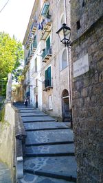 Low angle view of steps amidst buildings