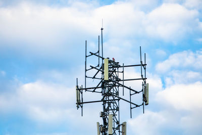 Low angle view of communications tower against sky