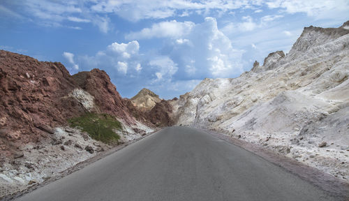 Road amidst mountains against sky