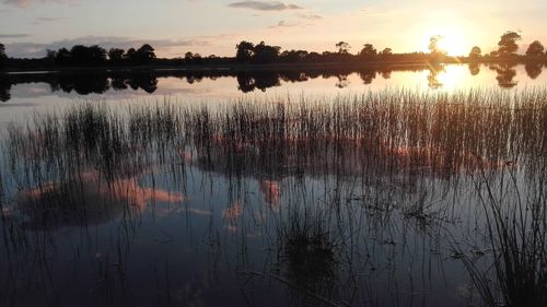 Scenic view of lake against sky during sunset