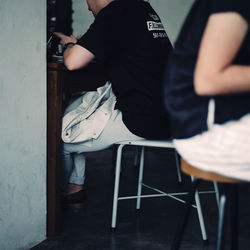 Low section of man sitting on chair